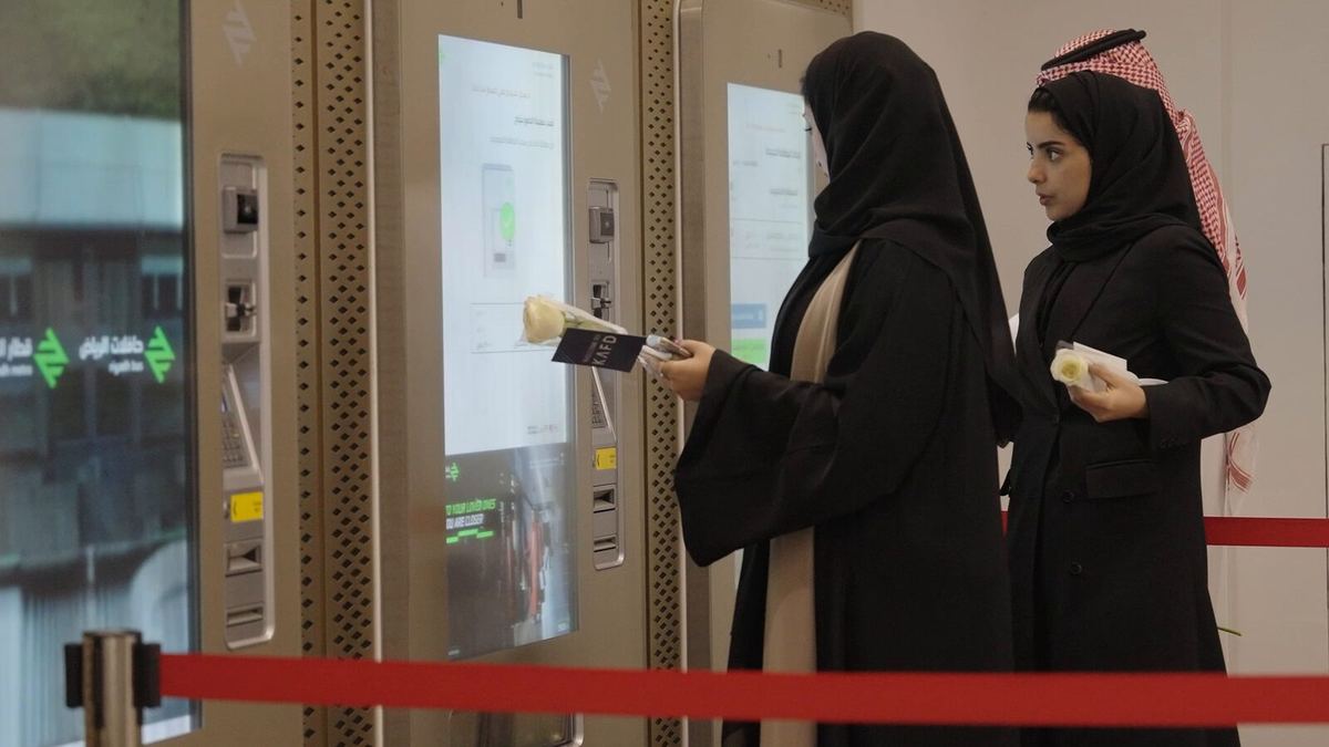 Passengers using a ticket machine