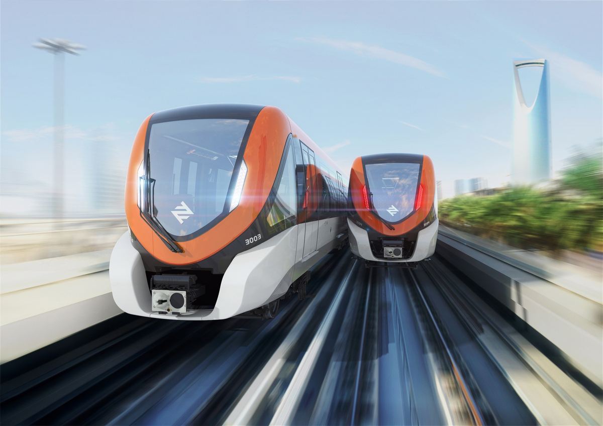 Two orange Line 3 trains with Kingdom Tower behind